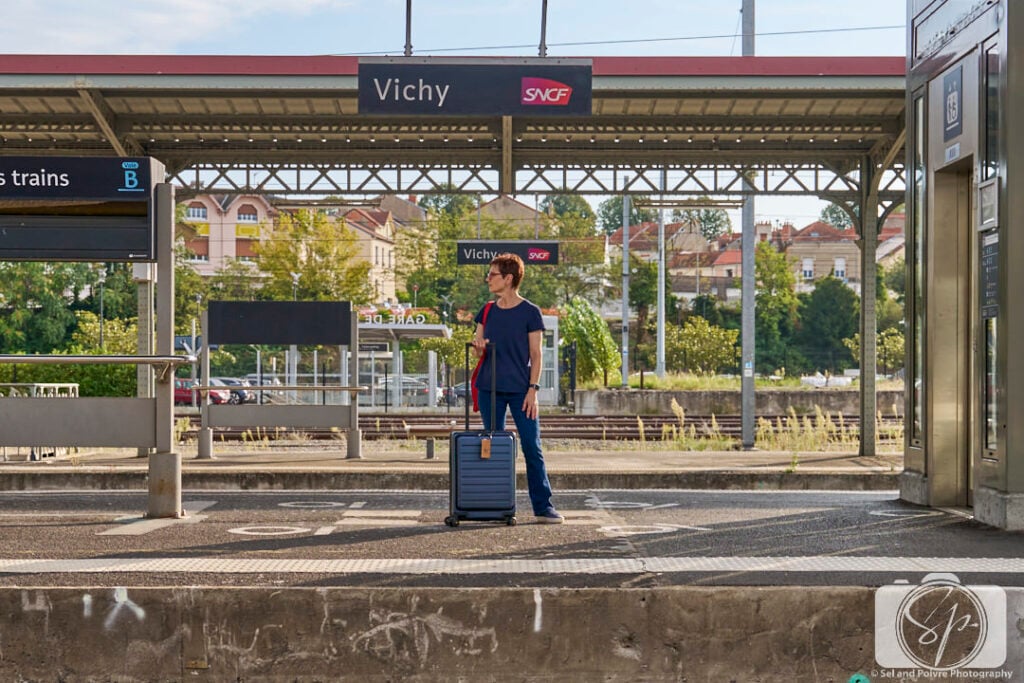 Andi at the Vichy Train Station with her LEVEL8 Suitcase