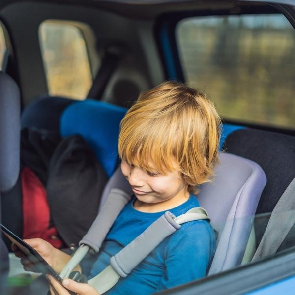 Kid with iPad in car