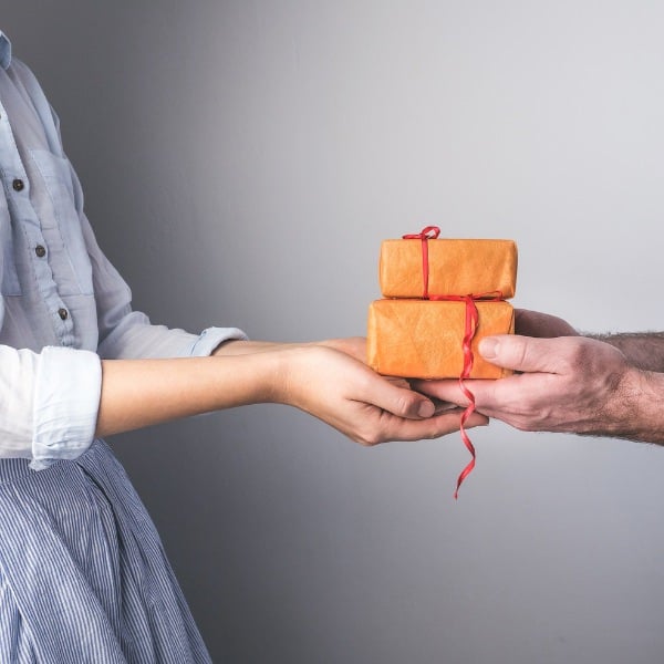 man giving woman a gift