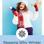 Excited young woman in hat and sweater holding passport and toy plane on blue