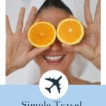 beauty in towel turban smiling with oranges